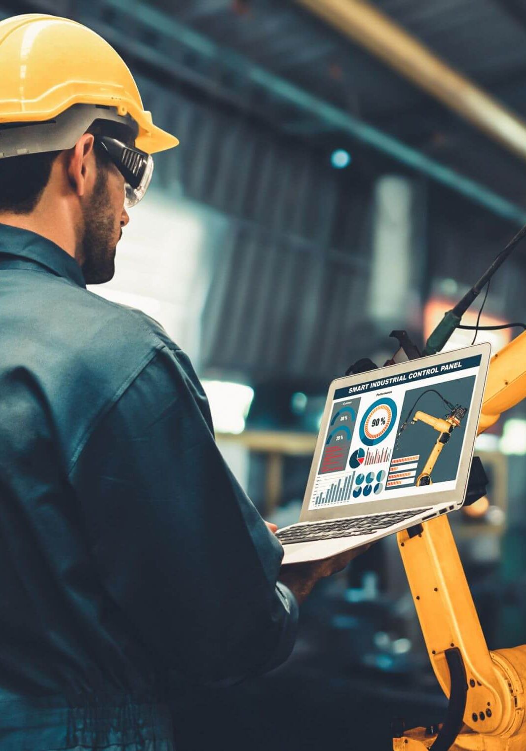 Man working with robotic manufacturing machine